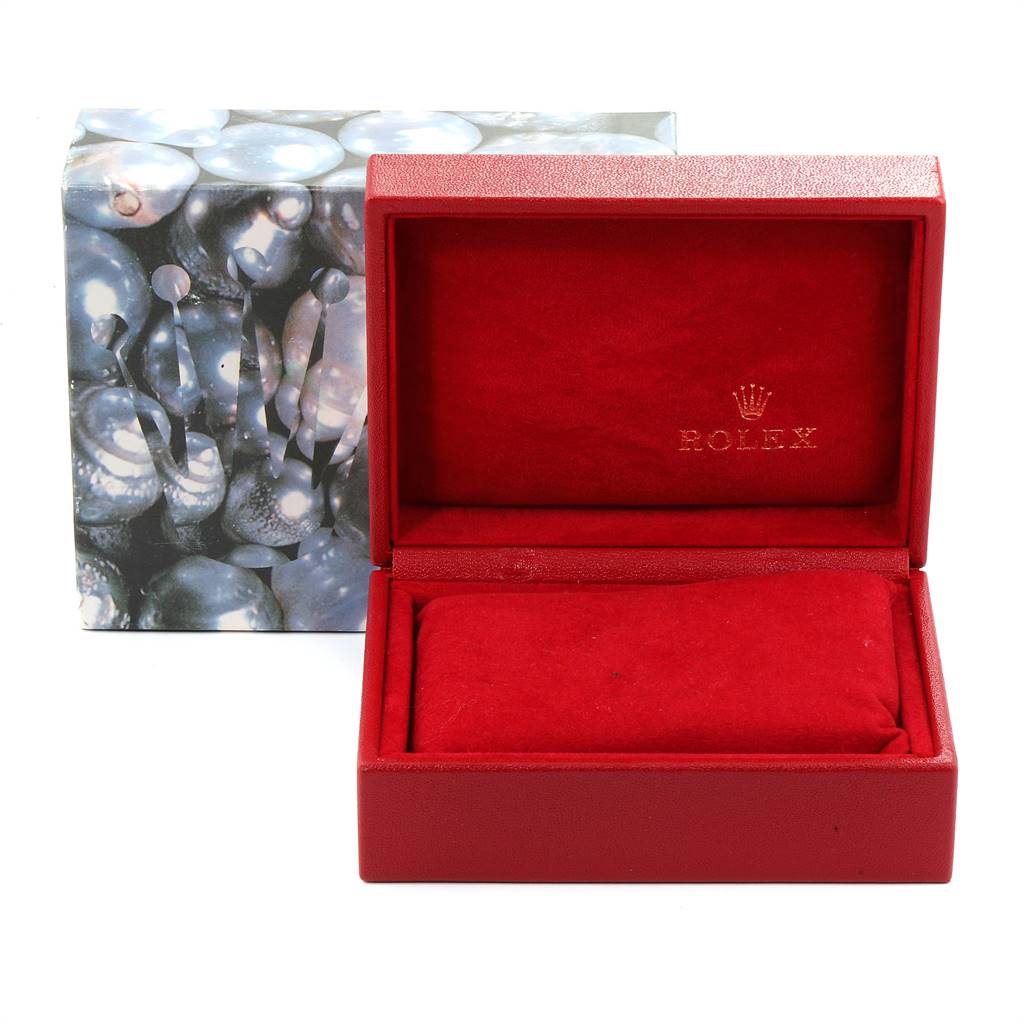 This image shows an open, empty red Rolex President 69178 Women's Yellow Gold Blue Dial 69178 Women's Yellow Gold Blue Dial model watch box with a decorated outer box in the background.