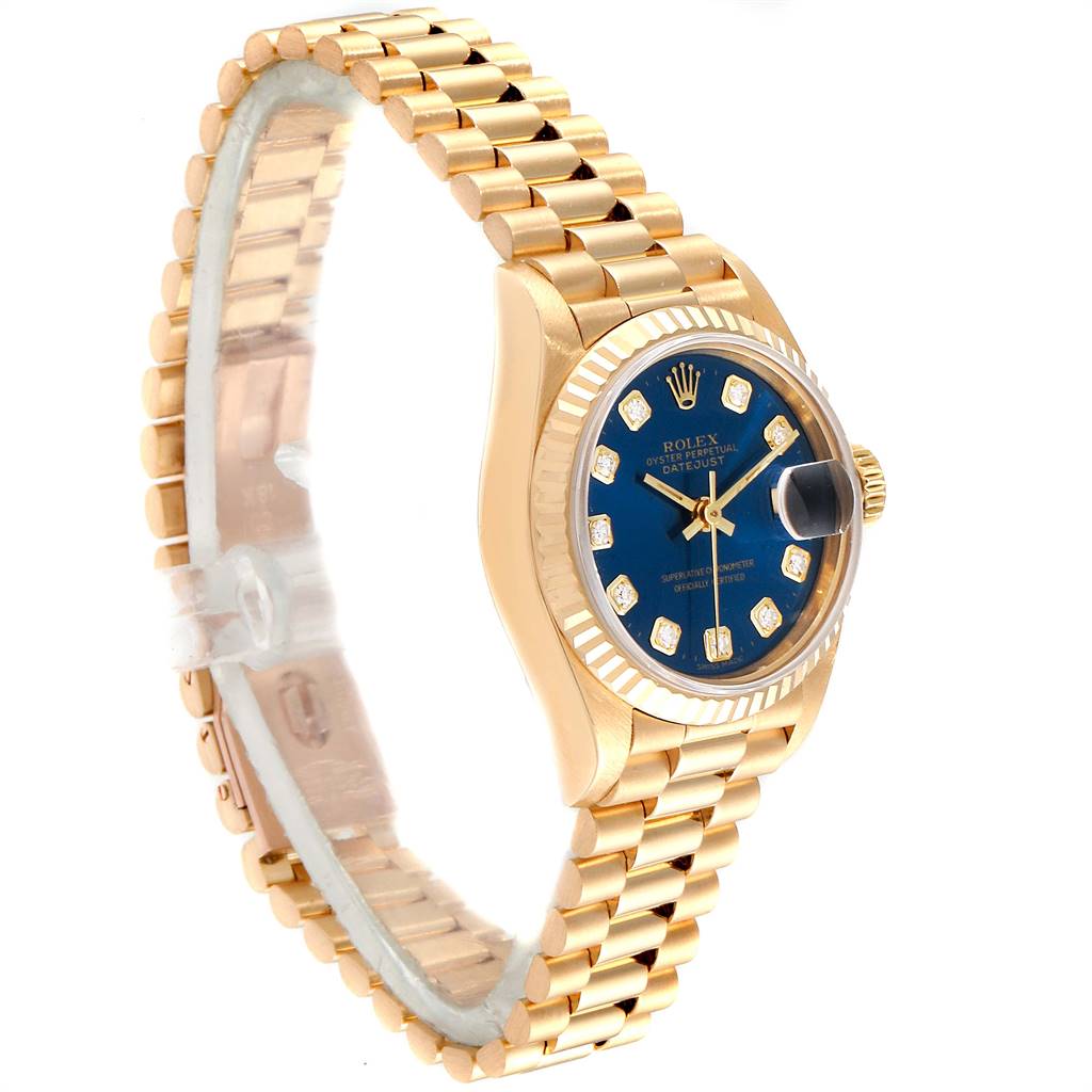 The image shows a Rolex President 69178 Women's Yellow Gold Blue Dial 69178 Women's Yellow Gold Blue Dial model watch at a three-quarter angle, displaying its gold bracelet and blue dial with diamond hour markers.