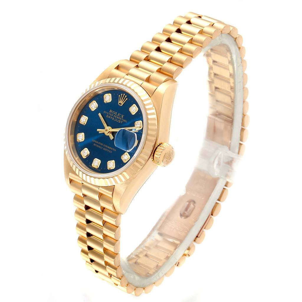 The Rolex President 69178 Women's Yellow Gold Blue Dial 69178 Women's Yellow Gold Blue Dial watch is shown at an angle displaying the face with a blue dial, bezel, crown, and gold bracelet.