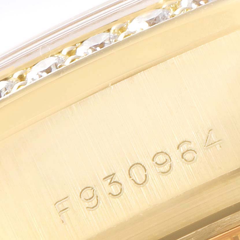 This image shows a close-up of the serial number and the diamond-set bezel of a Rolex President 179178 Women
s Yellow Gold Champagne Dial 179178 Women
s Yellow Gold Champagne Dial watch.