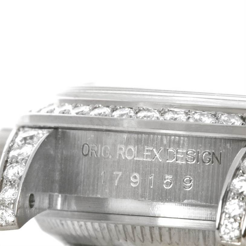 The image shows a close-up view of a Rolex President 179159 Women's White Gold Mother of Pearl Dial 179159 Women's White Gold Mother of Pearl Dial watch's side, featuring part of the case and diamond embellishments.