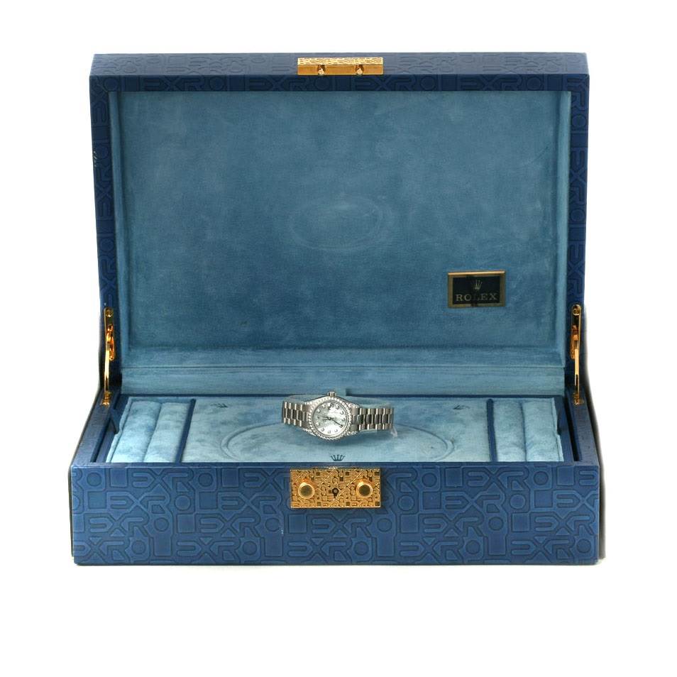 The image shows a Rolex President 179159 Women's White Gold Mother of Pearl Dial 179159 Women's White Gold Mother of Pearl Dial watch and its box, taken from a front angle, with the watch centered inside the open box.