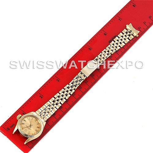 This image shows a Rolex President 6719 Women's Yellow Gold Champagne Dial 6719 Women's Yellow Gold Champagne Dial model watch laid flat next to a red ruler for scale.