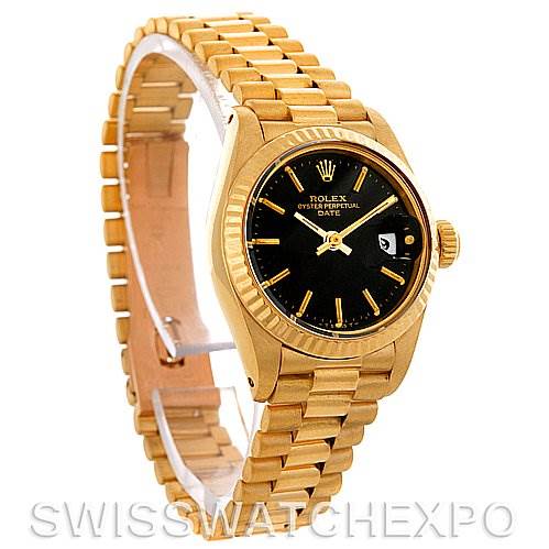 The image shows a side angle of a Rolex President 6917 Women's Yellow Gold Black Dial 6917 Women's Yellow Gold Black Dial model, highlighting its gold bracelet, black dial, and fluted bezel.