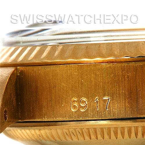 The image shows a close-up angle of the side of a Rolex President 6917 Women's Yellow Gold Black Dial 6917 Women's Yellow Gold Black Dial model, highlighting the serial number "6917" on the case.
