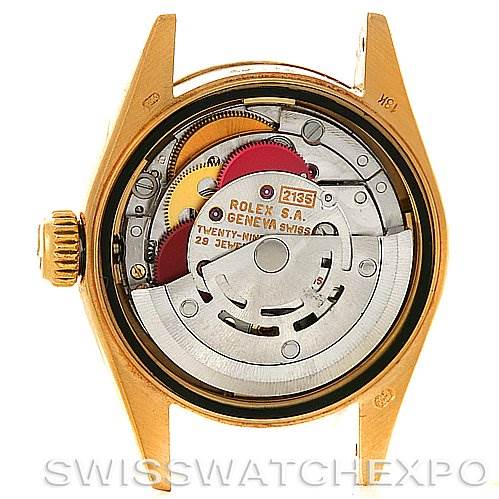 The image shows the internal movement of a Rolex President 69178 Women's Yellow Gold Champagne Dial 69178 Women's Yellow Gold Champagne Dial model, highlighting the mechanics and gears.