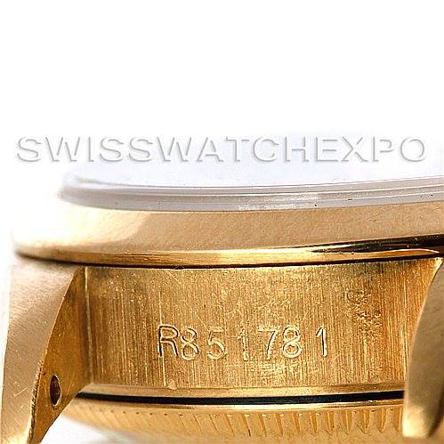 This image shows a close-up of the side of the Rolex President 67188 Women
s Yellow Gold Blue Dial 67188 Women
s Yellow Gold Blue Dial watch, highlighting the engraving on the gold case.