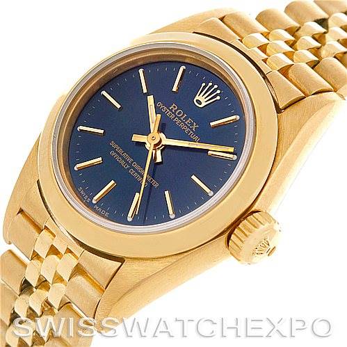 This image shows a close-up of the Rolex President 67188 Women
s Yellow Gold Blue Dial 67188 Women
s Yellow Gold Blue Dial model watch, featuring its gold case, blue dial, crown, and part of its bracelet.