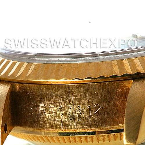 This image shows a close-up of the side of a Rolex President 69178 Women's Yellow Gold Black Dial 69178 Women's Yellow Gold Black Dial model, displaying the serial number and part of the fluted bezel.