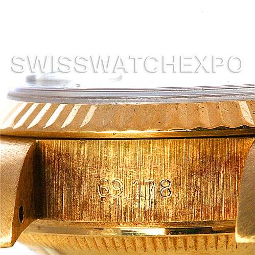 The image shows a close-up of the side of a Rolex President 69178 Women's Yellow Gold Black Dial 69178 Women's Yellow Gold Black Dial model watch, focusing on the serial number area and the fluted bezel.