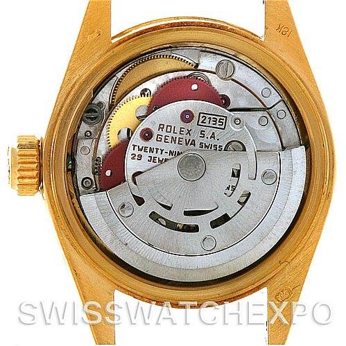 The image shows the inner mechanism of a Rolex President 69178 Women's Yellow Gold Black Dial 69178 Women's Yellow Gold Black Dial model watch, focusing on the movement and rotor.