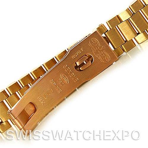 This image shows a close-up of the clasp and part of the bracelet of a Rolex President 69178 Women's Yellow Gold Black Dial 69178 Women's Yellow Gold Black Dial model watch, including engravings on the clasp.