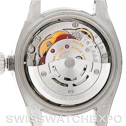 This image shows the movement and inner mechanism of a Rolex watch, viewed from the back with the case opened.