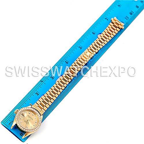 The image shows a Rolex President 69278 Women's Yellow Gold Champagne Dial 69278 Women's Yellow Gold Champagne Dial model watch laid flat next to a blue ruler, displaying the full bracelet and watch face.
