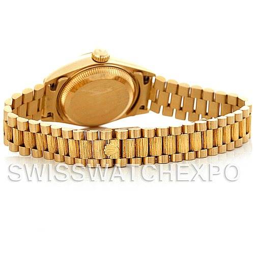 The image shows the backside of a Rolex President 69278 Women's Yellow Gold White Dial 69278 Women's Yellow Gold White Dial model watch, focusing on the case back and the gold bracelet.