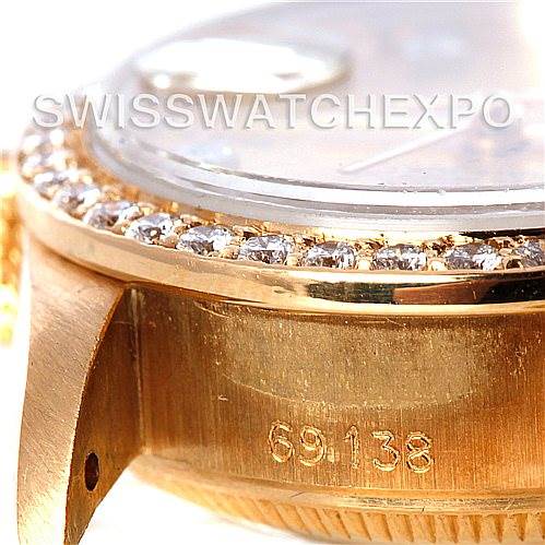 The image shows a close-up of the Rolex President 69138 Women's Yellow Gold Champagne Dial 69138 Women's Yellow Gold Champagne Dial model watch case, focusing on the diamond bezel and part of the side, featuring a serial number.