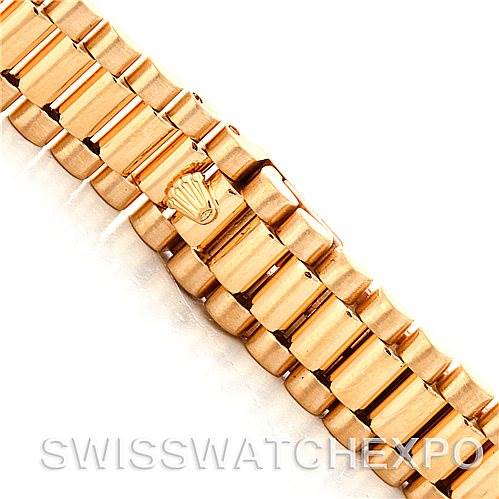 This image shows a close-up view of the bracelet of a Rolex President 69138 Women's Yellow Gold Champagne Dial 69138 Women's Yellow Gold Champagne Dial model watch, highlighting its signature design and logo.