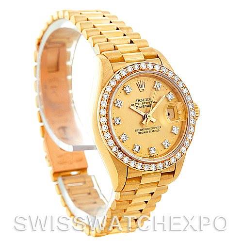The image shows a Rolex President 69138 Women's Yellow Gold Champagne Dial 69138 Women's Yellow Gold Champagne Dial model watch from an angled front view, highlighting its gold band, diamond bezel, and dial.