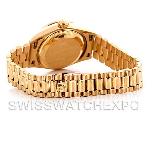 The image shows a Rolex President 69138 Women's Yellow Gold Champagne Dial 69138 Women's Yellow Gold Champagne Dial model watch from the back, displaying the caseback and President bracelet.