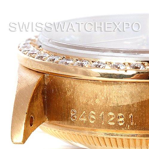 This image shows a close-up of the side of a Rolex President 69138 Women's Yellow Gold Champagne Dial 69138 Women's Yellow Gold Champagne Dial watch case, showcasing its serial number and diamond bezel.