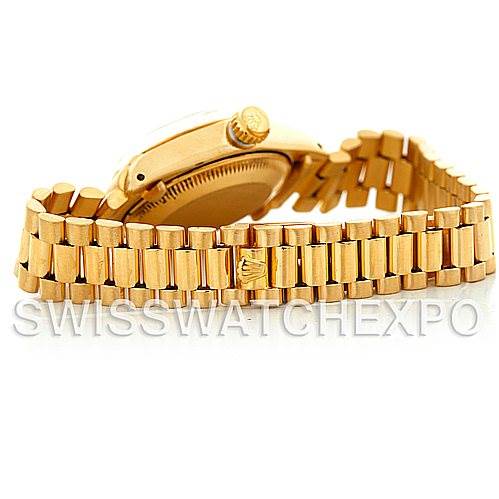 The image shows a side view of the Rolex President 6917 Women's Yellow Gold Champagne Dial 6917 Women's Yellow Gold Champagne Dial model, focusing on the gold bracelet and crown.