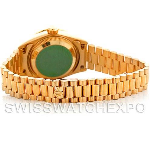 The image shows the back view of a Rolex President 69068 Women
s Yellow Gold Mother of Pearl Dial 69068 Women
s Yellow Gold Mother of Pearl Dial model watch, highlighting its gold bracelet and case back.