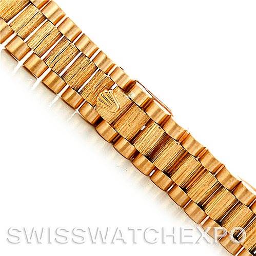The image shows a close-up of the gold bracelet of a Rolex President 69278 Women's Yellow Gold Champagne Dial 69278 Women's Yellow Gold Champagne Dial model watch, emphasizing the clasp with the Rolex logo.