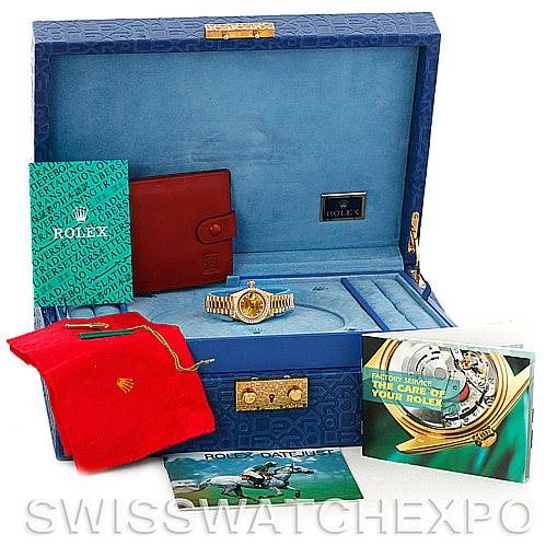 This image shows a Rolex President 69138 Women's Yellow Gold Champagne Dial 69138 Women's Yellow Gold Champagne Dial watch with its accessories, including the box, booklets, and a red pouch, all viewed from a front angle.