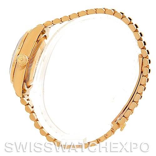 This is a side view of a Rolex President 69138 Women's Yellow Gold Champagne Dial 69138 Women's Yellow Gold Champagne Dial model watch, showcasing the crown, case, and part of the bracelet.