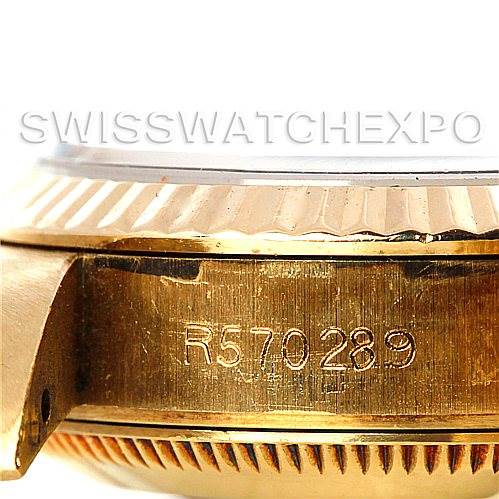 This image shows a close-up side view of a Rolex President 67197 Women's Yellow Gold Champagne Dial 67197 Women's Yellow Gold Champagne Dial watch, highlighting its serial number and part of the case.