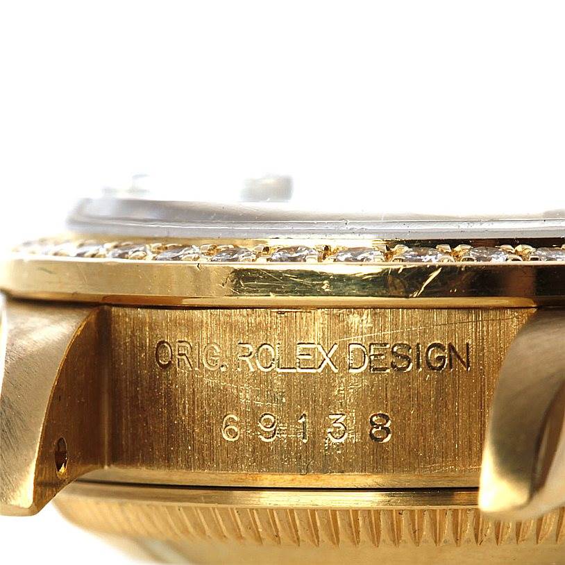 This close-up angle of the Rolex President 69138 Women's Yellow Gold Blue Dial 69138 Women's Yellow Gold Blue Dial model showcases its bezel, case, and lugs, highlighting the engraving.