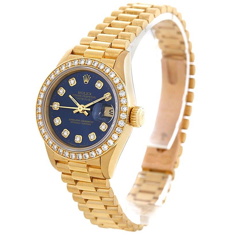 The image shows a Rolex President 69138 Women's Yellow Gold Blue Dial 69138 Women's Yellow Gold Blue Dial model watch angled slightly from the front, featuring its gold case, bracelet, and diamond-encrusted bezel.