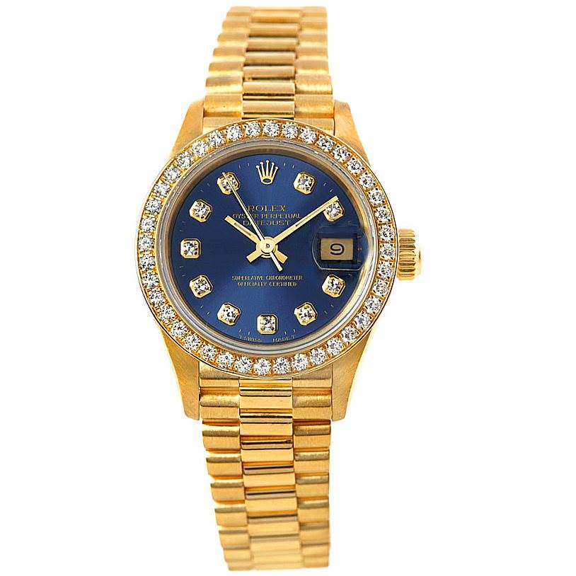 The image shows a Rolex President 69138 Women's Yellow Gold Blue Dial 69138 Women's Yellow Gold Blue Dial model watch from a front angle, displaying its gold bracelet, diamond bezel, and blue dial with gold markers.
