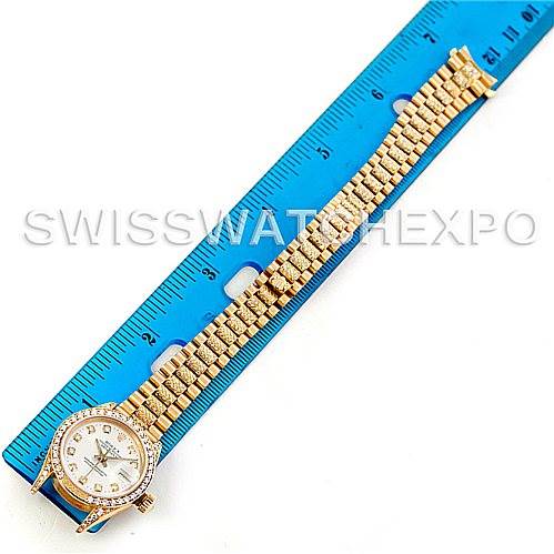 The image shows a Rolex President 69158 Women's Yellow Gold Champagne Dial 69158 Women's Yellow Gold Champagne Dial model watch, face up, alongside a ruler to indicate its length and bracelet size.