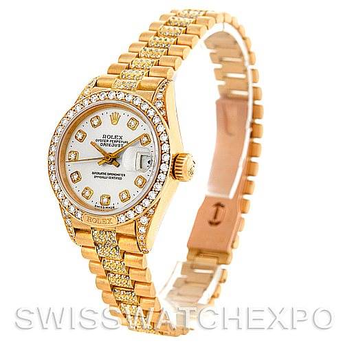 The image displays a side view of the Rolex President 69158 Women's Yellow Gold Champagne Dial 69158 Women's Yellow Gold Champagne Dial model watch, highlighting its gold bracelet, jeweled bezel, and dial.