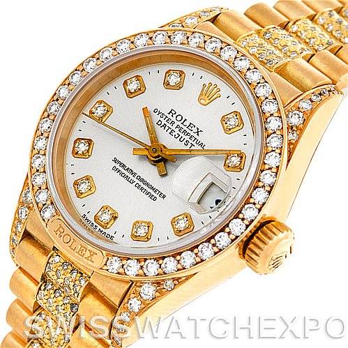 This image shows the face, bezel, and part of the bracelet of the Rolex President 69158 Women's Yellow Gold Champagne Dial 69158 Women's Yellow Gold Champagne Dial model, adorned with diamonds.