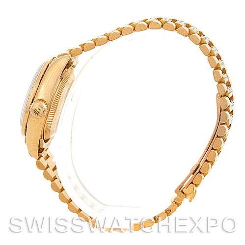 This image shows a side view of a Rolex President 69158 Women's Yellow Gold Champagne Dial 69158 Women's Yellow Gold Champagne Dial model watch, highlighting the crown and bracelet.