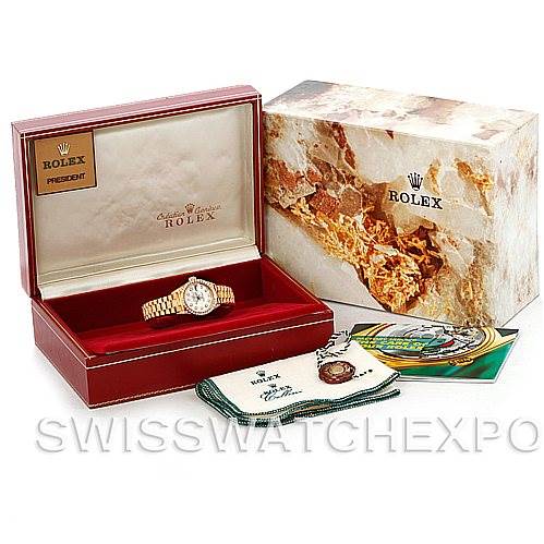 This image shows a Rolex President 69158 Women's Yellow Gold Champagne Dial 69158 Women's Yellow Gold Champagne Dial model watch in its box, accompanied by its outer packaging, manuals, and accessories.