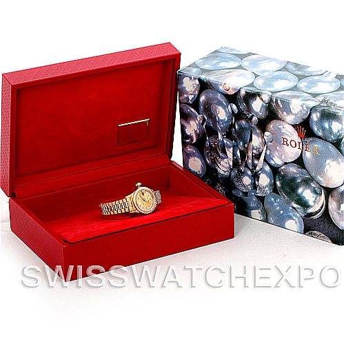 The image shows a Rolex President 69158 Women's Yellow Gold Champagne Dial 69158 Women's Yellow Gold Champagne Dial watch displayed in an open red box next to a closed decorative Rolex packaging box.