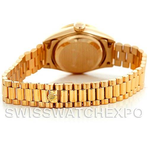 The image shows the back view of a Rolex President 69158 Women's Yellow Gold Champagne Dial 69158 Women's Yellow Gold Champagne Dial model watch, highlighting its gold case and linked bracelet.
