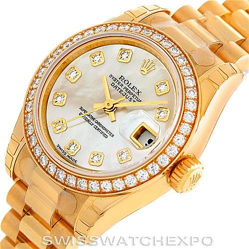 This image shows a Rolex President 179138 Women's Yellow Gold Mother of Pearl Dial 179138 Women's Yellow Gold Mother of Pearl Dial model watch from an oblique angle, highlighting the diamond-studded bezel, face, and part of the bracelet.