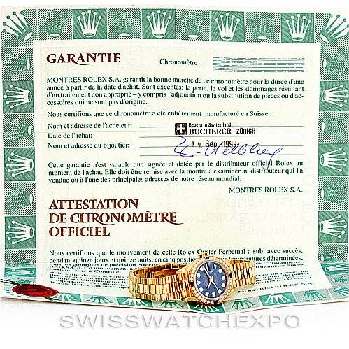 The image shows a Rolex President 69088 Women's Yellow Gold Blue Dial 69088 Women's Yellow Gold Blue Dial model watch placed on top of its official Garantie and Attestation documents.