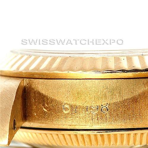 This image shows a close-up side view of the Rolex President 67198 Women's Yellow Gold Champagne Dial 67198 Women's Yellow Gold Champagne Dial model watch, highlighting the gold casing and the serial number engraving.
