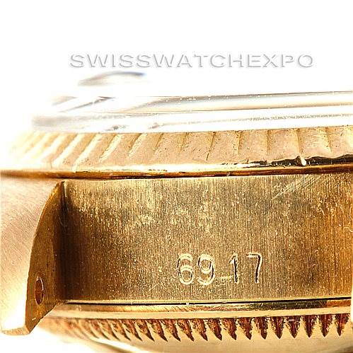 This close-up image of a Rolex President 6917 Women's Yellow Gold Champagne Dial 6917 Women's Yellow Gold Champagne Dial watch shows the gold bezel, case side, and lug, with engraved numbers "6917".