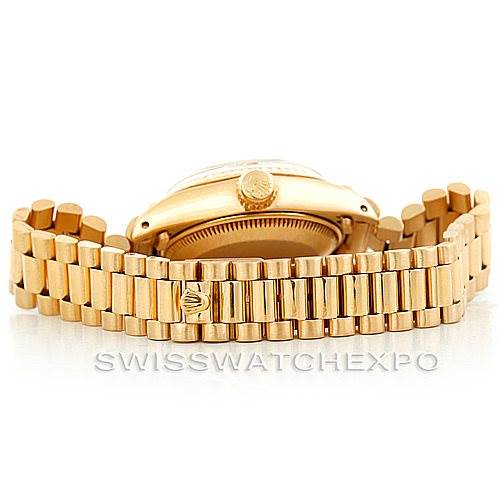 The image shows the side and bracelet of a Rolex President 6917 Women's Yellow Gold Champagne Dial 6917 Women's Yellow Gold Champagne Dial model watch, highlighting the crown and gold links.