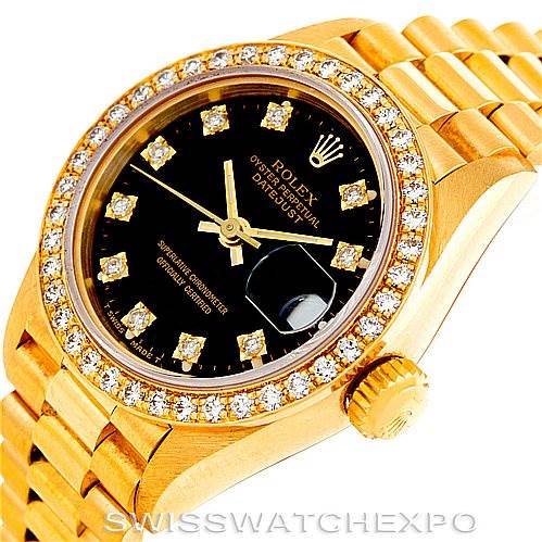 The image shows a close-up angled view of the Rolex President 69178 Women's Yellow Gold Black Dial 69178 Women's Yellow Gold Black Dial model watch, highlighting its gold bezel, dial, crown, and diamond hour markers.