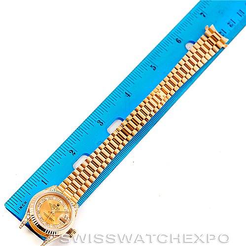 The image shows a Rolex President 69238 Women's Yellow Gold Champagne Dial 69238 Women's Yellow Gold Champagne Dial watch laid flat next to a blue ruler for measurement.