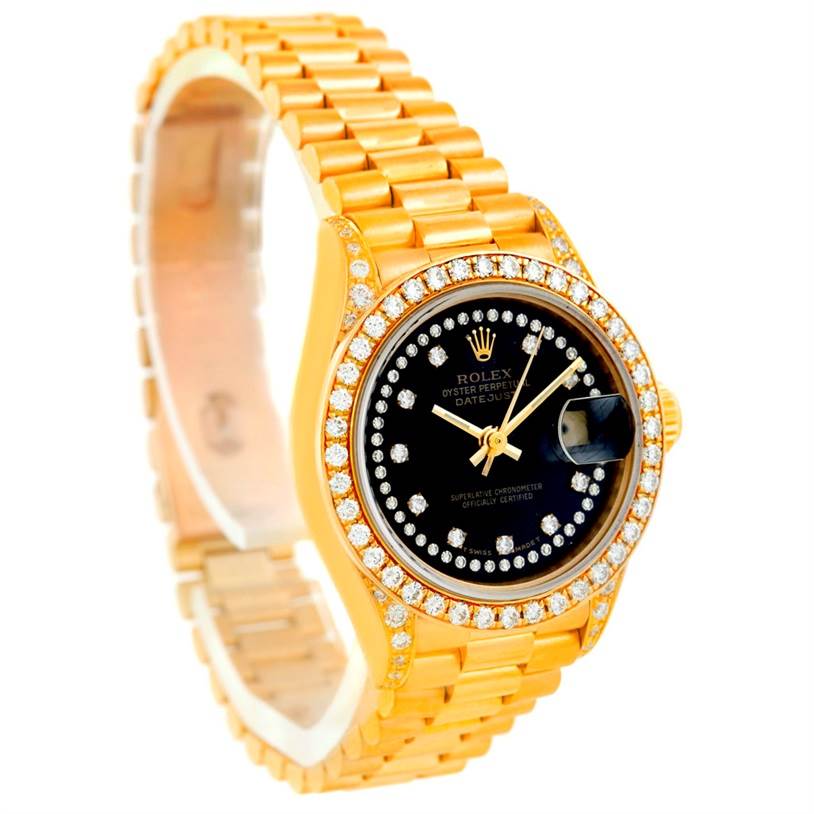 The image shows a Rolex President 69158 Women's Yellow Gold Black Dial 69158 Women's Yellow Gold Black Dial model watch with a gold bracelet and a black, diamond-studded dial, viewed at an angle.