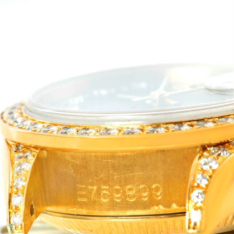 This close-up angle shows the side of the Rolex President 69158 Women's Yellow Gold Black Dial 69158 Women's Yellow Gold Black Dial watch with a focus on its serial number and diamond-studded bezel and lugs.