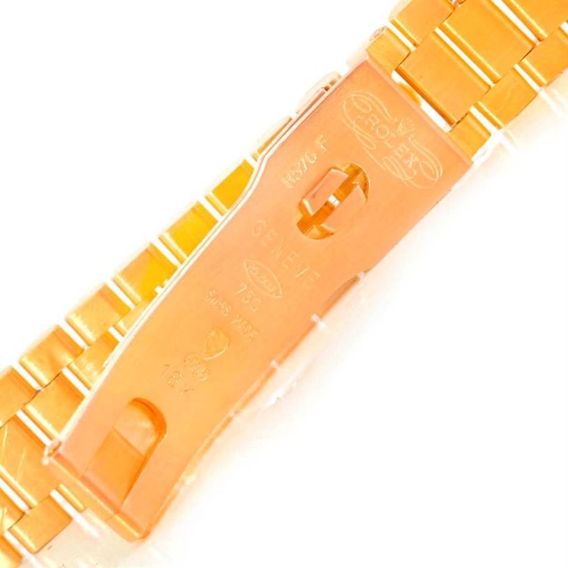 The image shows the clasp of a Rolex President 69158 Women's Yellow Gold Black Dial 69158 Women's Yellow Gold Black Dial model watch, viewed from the back, displaying its engravings and logo.